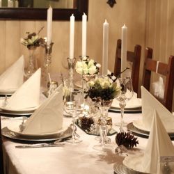 Dekket bord i hvitt, med innslag av kongler, diamanter og snø…